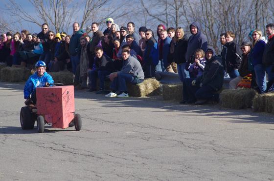 Pine Hill derby participant going down Pine Hill with spectators watching